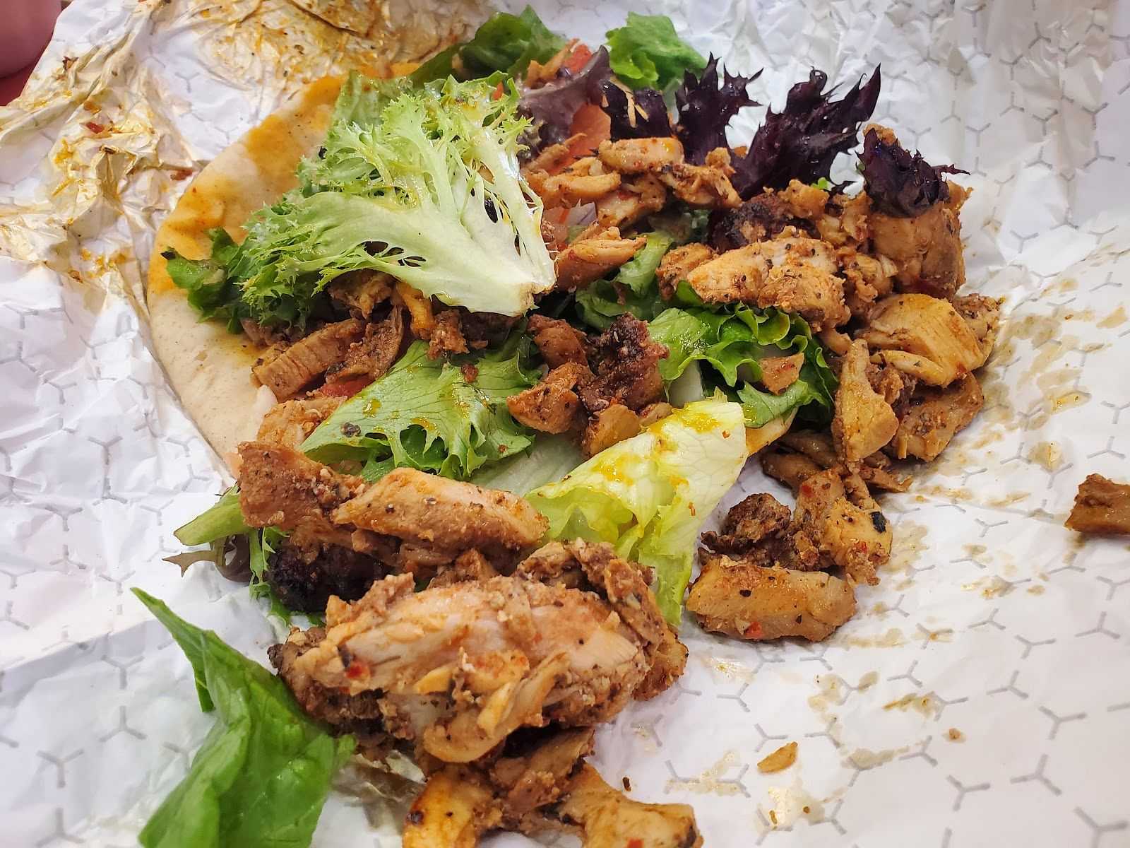 Pita with chicken on a to-go wrapper